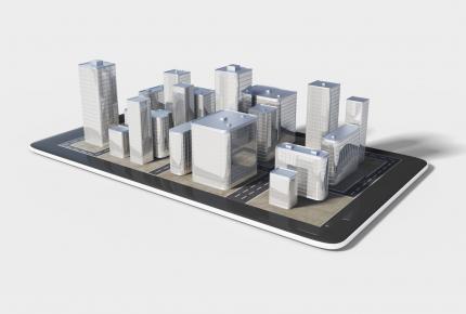 des immeubles en 3D qui se sortent d'une tablette numérique 